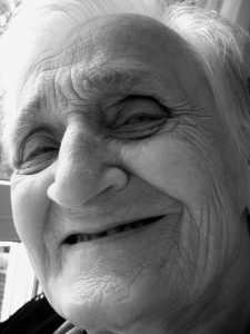 “woman-76527_960_720.jpg” by geralt is licensed under CC0 Image showing an elderly woman smiling