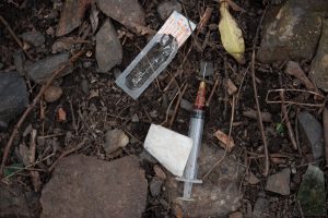 “Heroin syringe” by Thomas Marthinsen is licensed under CC BY-NC-SA 2.0 Photo showing a closeup of a used syringe and packaging litter