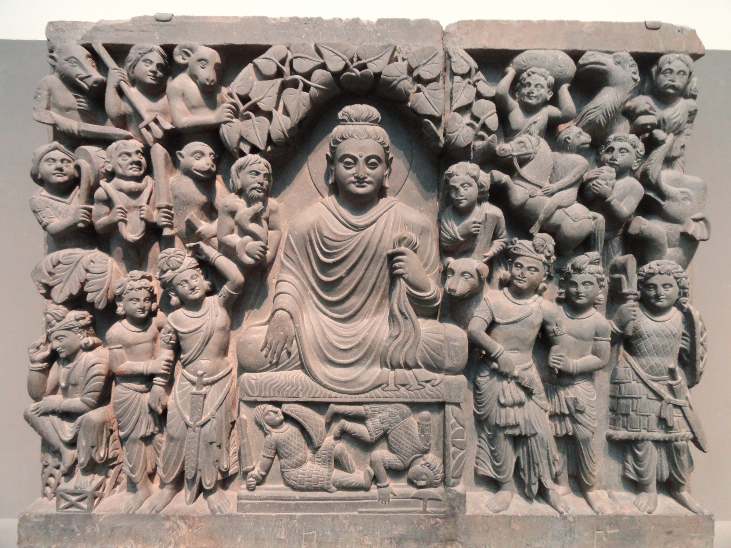 “Four_Scenes_from_the_Life_of_the_Buddha_-_Enlightenment_-_Kushan_dynasty,_late_2nd_to_early_3rd_century_AD,_Gandhara,_schist_-_Freer_Gallery_of_Art_-_DSC05124.JPG” by Daderot is in the Public Domain, CC0 Photo showing Four Scenes from the Life of the Buddha - Enlightenment - Kushan dynasty, late 2nd to early 3rd century AD, Gandhara, schist