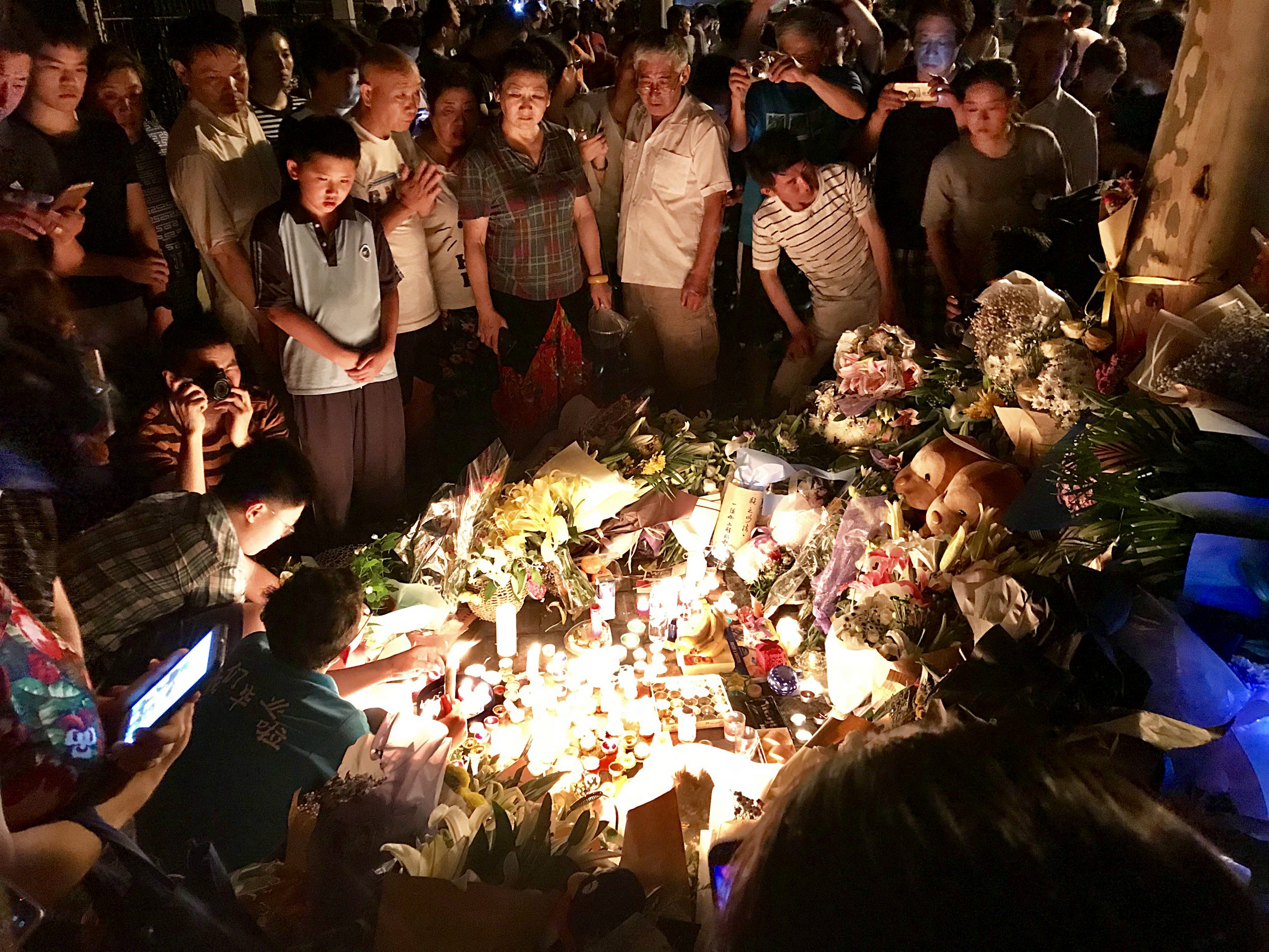Mourning_in_Shanghai_(1).jpg” by Medalofdead is licensed under CC BY-SA 4.0 Image showing a Community Grieving at a candlelight vigil