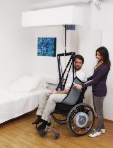 “User-Integra-lifter1.jpg” by Integracp is licensed under CC BY-SA 3.0 Photo showing a patient being transferred from wheelchair using a patient lift