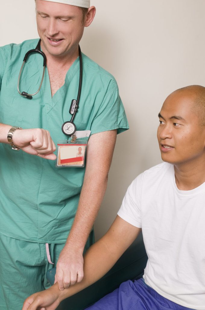 “13394660711603.jpg” by CDC/ Amanda Mills is in the Public Domain Photo showing nurse checking patient's pulse