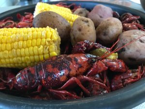 Crawfish Boil with corn on the cob, crawfish, and potatoes.
