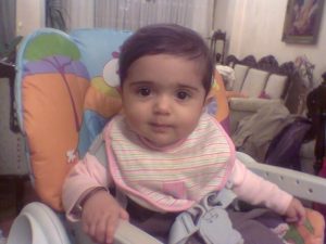 Photo of a toddler sitting in a high chair.