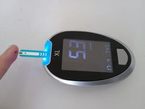 Image of a glucose monitor being used to test blood sugar levels