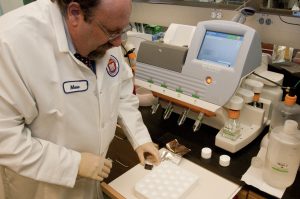 Scientist Marc Allard at FDA's comparative genomics laboratory uses a desktop gene sequencing machine to identify the genetic makeup of bacteria that cause food-borne illnesses.