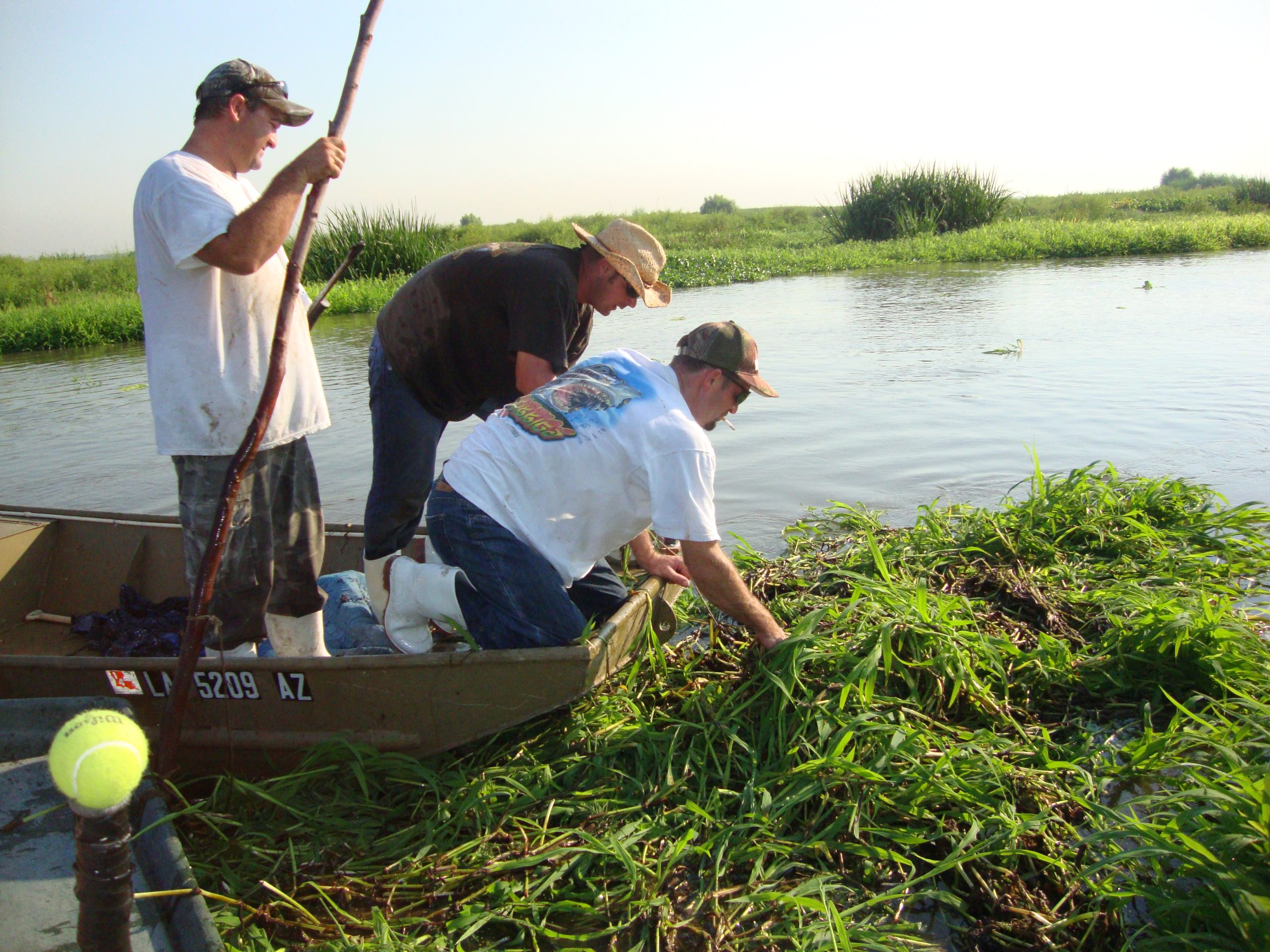 Image of three men in a boat hunting alligators in Louisiana