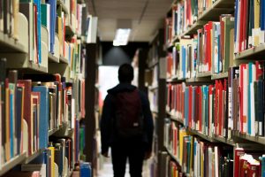 person walking through a library