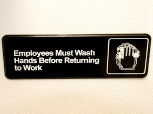 11.3.8 ImageA sign telling employees they must wash hands before returning to work
