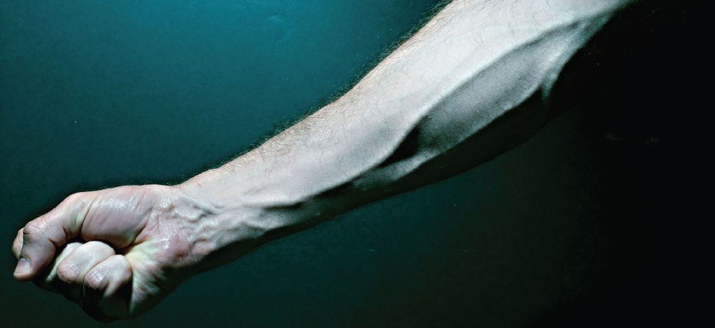 Shows a forearm with the veins bulging