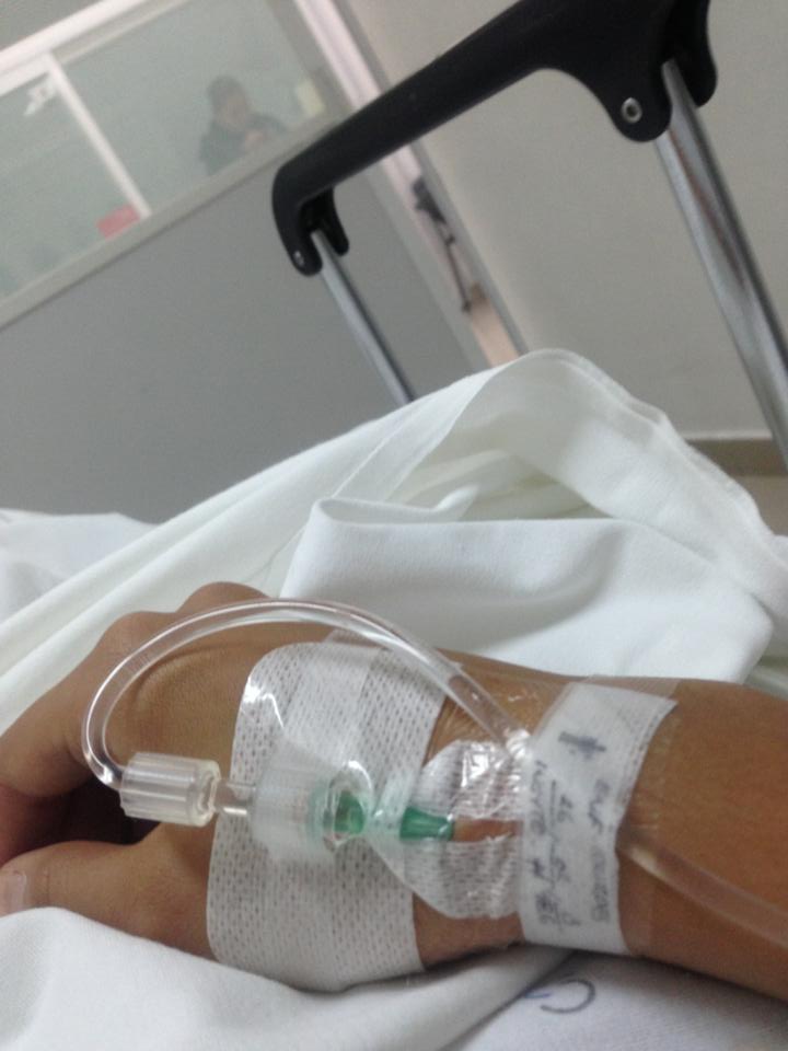 Arm resting in hospital bed with IV inserted