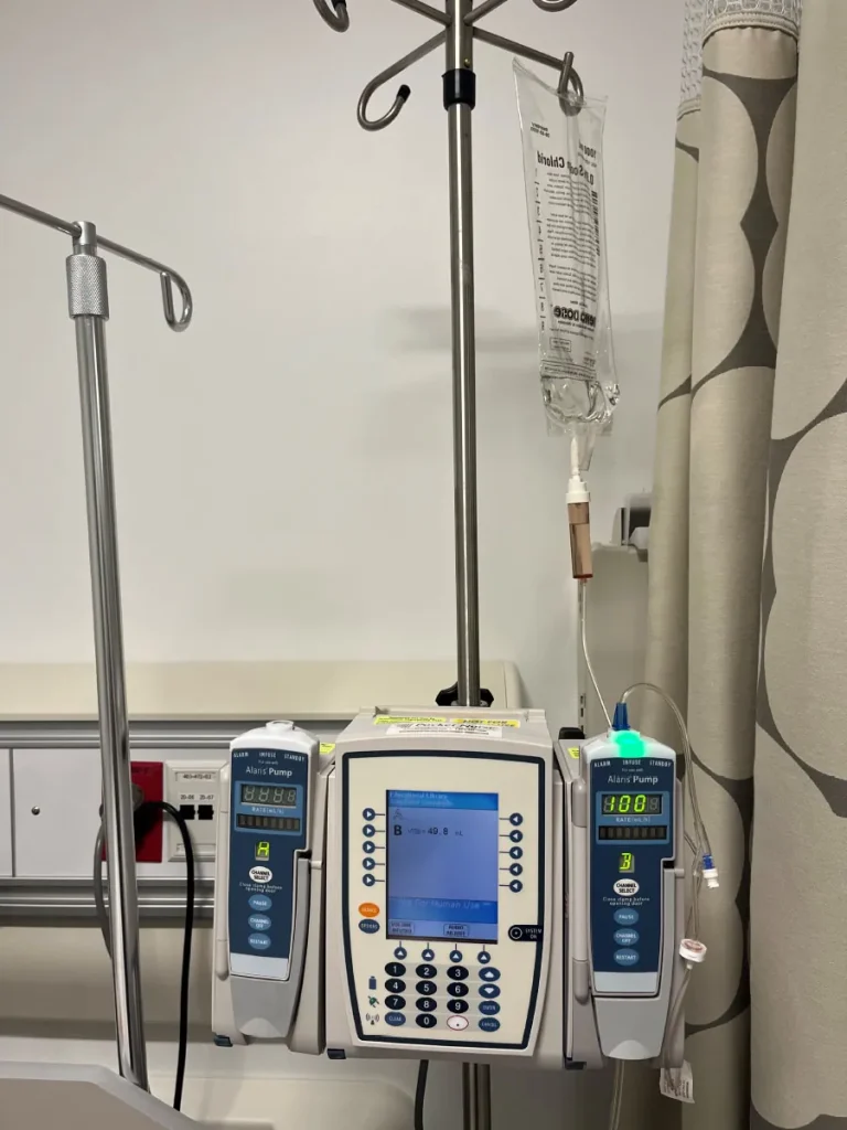 A photograph shows an electronic IV pump