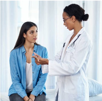 A photograph of a patient and a physician in consultation.