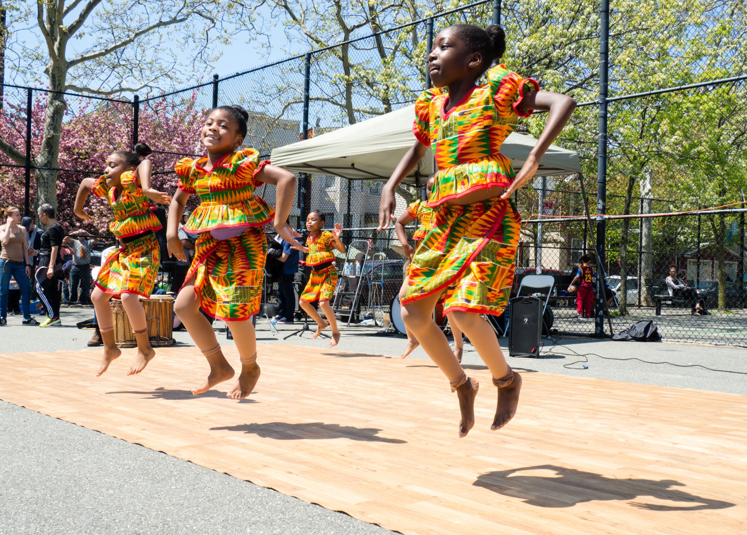 Kids jumping while dancing in colorful dress