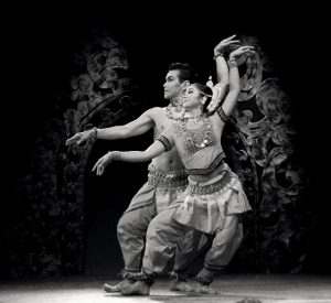 Grey scale image of traditionally costumed dancers.