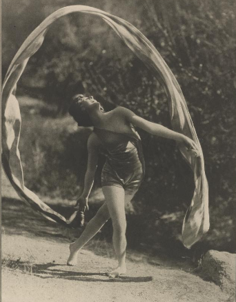 Woman dancing with a long piece of material