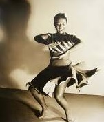 A black and white photo of Perl Primus dancing.