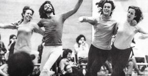 Blcak and white photo of two couples running and dancing.