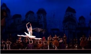 Photo of a ballerina as she leaps through the air in a grand jeté.