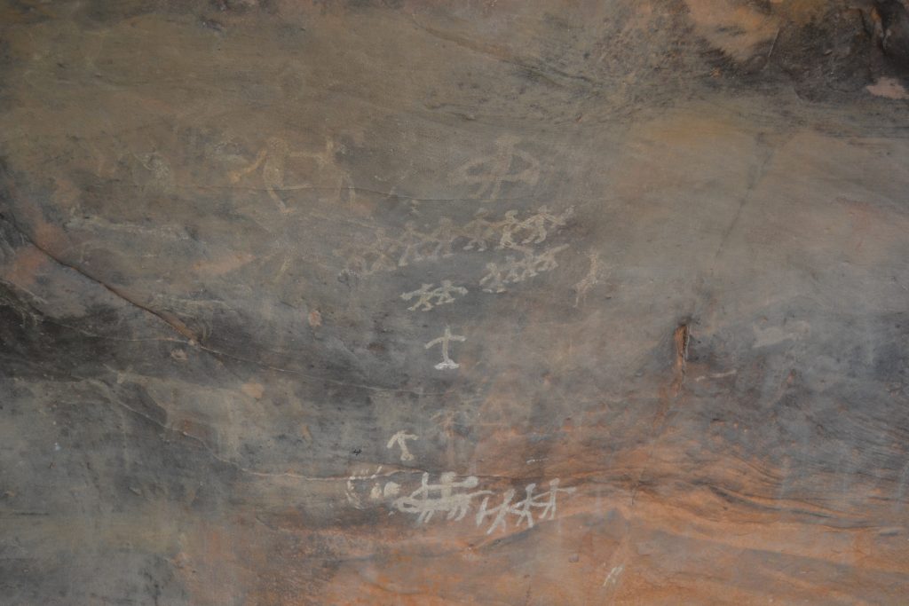 A photograph of a cave painting depicting early dancers.