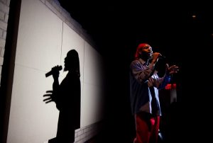 A photograph of a Hip Hop performer on stage.