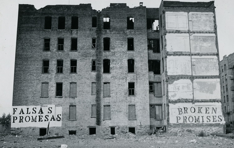 A photo of an old multi story building in a state of collapse.