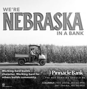 Pinnacle Bank advertisement that reads, "We're Nebraska in a Bank." With a tractor at a farm in the foreground.