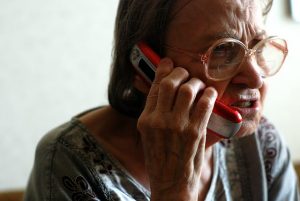 “5012292106_507e008c7a_o.jpg” by borosjuli is licensed under CC BY 2.0 Image of elderly woman talking on a cell phone