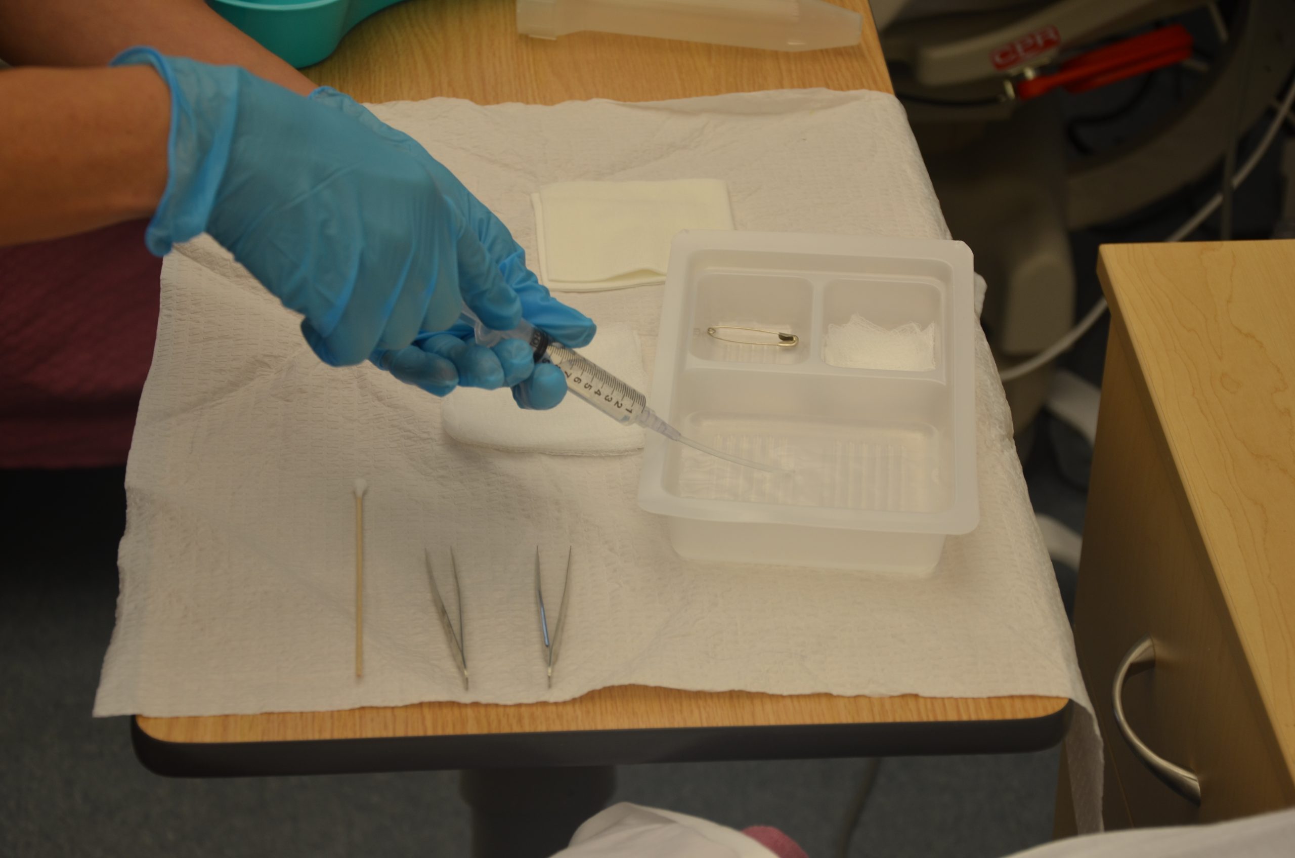 Fill syringe with irrigating solution