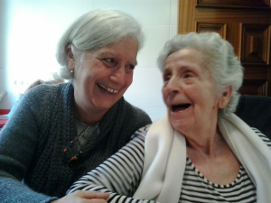 “My_mum_ill_with_dementia_with_me.png” by MariaMagdalens is licensed under CC BY-SA 4.0 Image showing two older women sitting next to each other and laughing