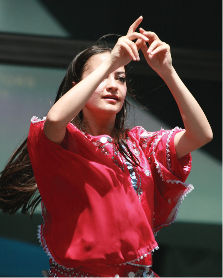 A person in a red shirt doing sign language.