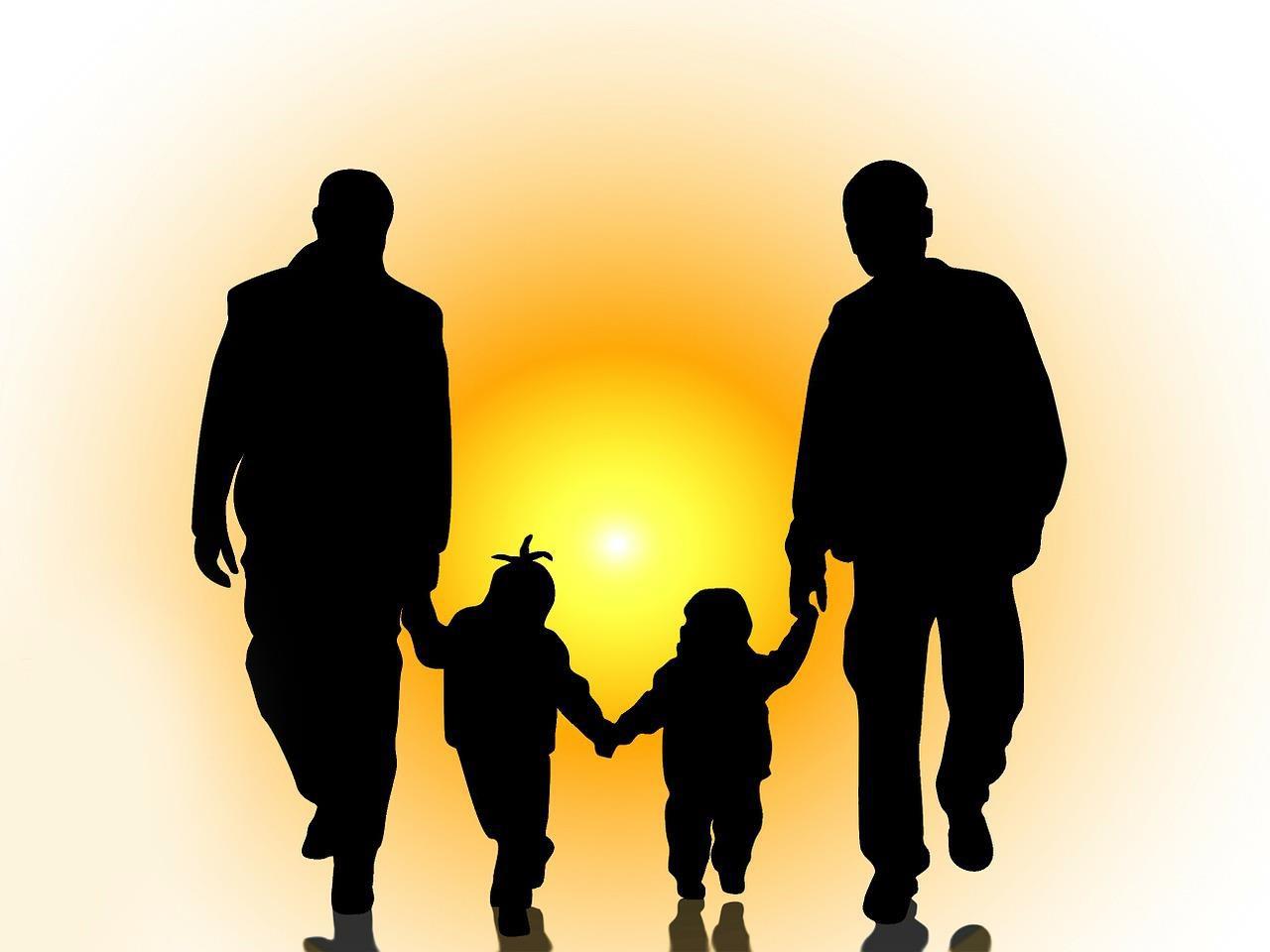 A drawing of family holding hands. The dads are on each side and the kids are in the middle.