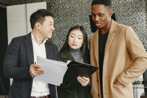 A Man in Gray Suit Showing Contract to His Clients