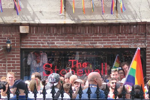 Group of people standing in front of the Stonewall Inn.