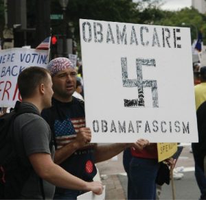Person holding a sign aboiut Obamacare.