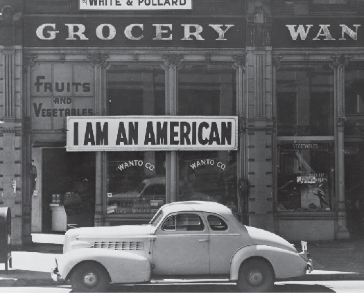 Storefront with a sign reading "I am an American."