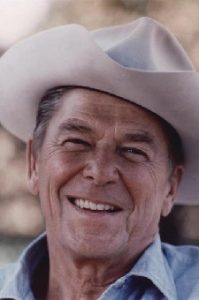 Ronald Reagan wearing a cowboy hat and denim shirt.