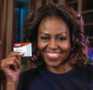 Michelle Obama holding an AARP membership card.