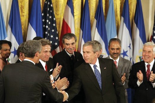 George W. Bush shaking hands with legislators and administration officials.