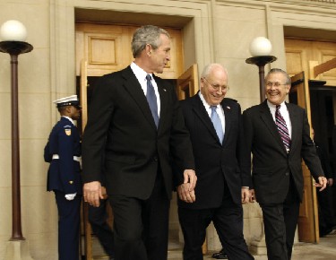 Donald Rumsfeld, George W. Bush, and Dick Cheney walking together.