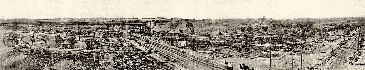 Panorama showing the devastation of the Greenwood neighborhood after the riot with few buildings remaining and smoke still rising from some areas