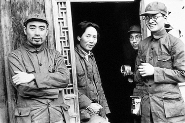 Group of men leaning against wall and doorway of building for photograph including Zhou Enlai (left) and Mao Zedong (middle)