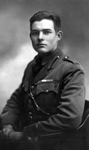 Seated photographic portrait of a young Ernest Hemingway in military uniform