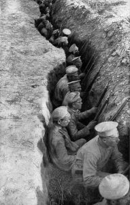 View looking down into trenches with Russian troops, guns at the ready, waiting for a German attack