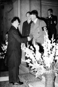 Adolf Hitler shaking hands with UK Prime Minister Neville Chamberlain