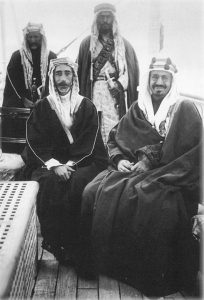 Ibn Saud (right, in glasses) seated with Iraqi King Faisal (left)