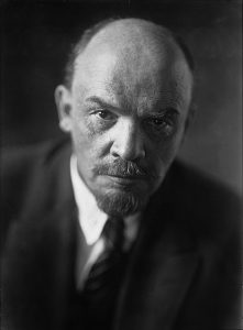 Photographic portrait of Lenin leaning forward looking directly into camera