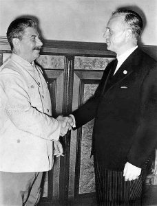 Stalin on left shaking hands with German Foreign Minister Ribbentrop
