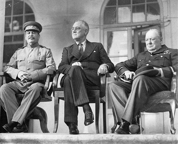 Seated portrait of Stalin (left), FDR (middle), and Churchill (right) at the Tehran Conference