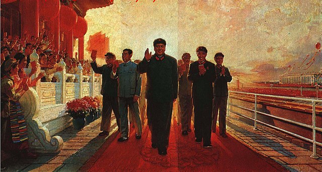 Propaganda painting of Mao Zedong walking towards the view with his hand lifted in a wave and smile followed by a group of his students with throngs of people cheering them on